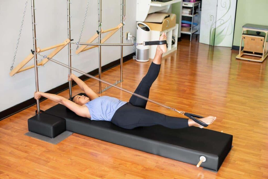 Person using the CenterLine Pole System for Pilates exercises.