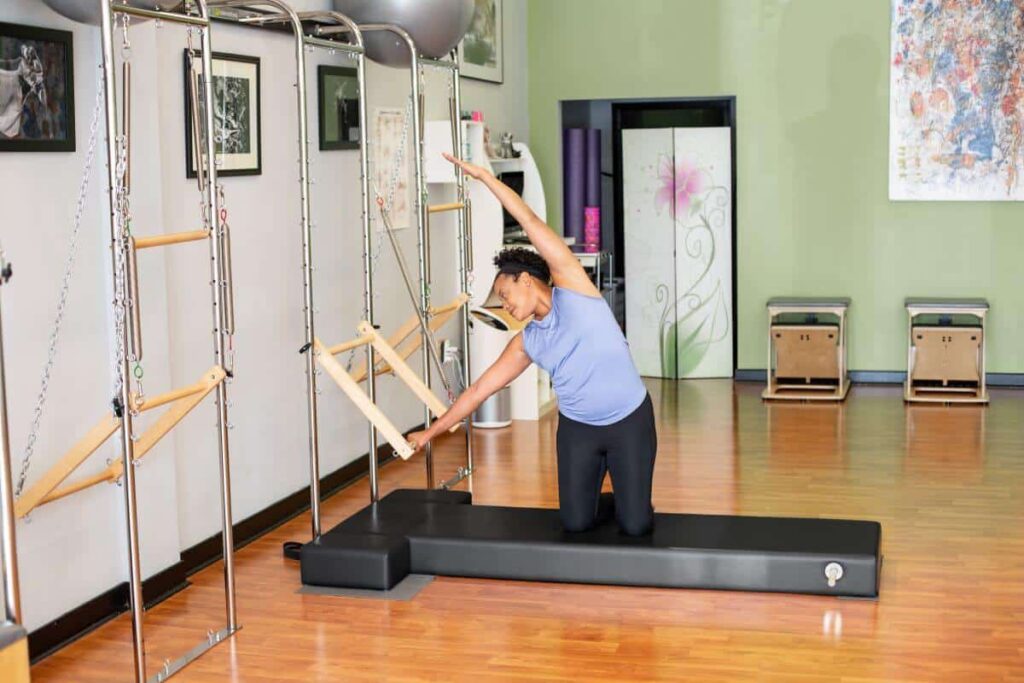 Person using CenterLine Pole System for Pilates exercises.
