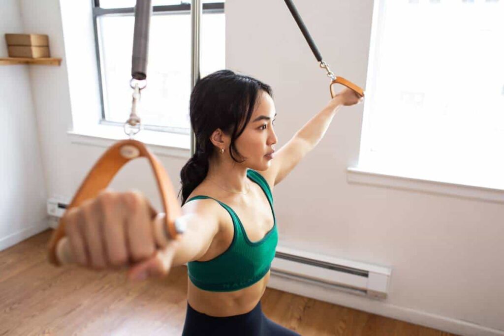 Pilates exercise using Contrology Contoured Leather Handles.