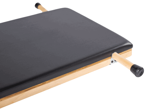 Elevated Pilates product with durable black upholstery and ergonomic grips.