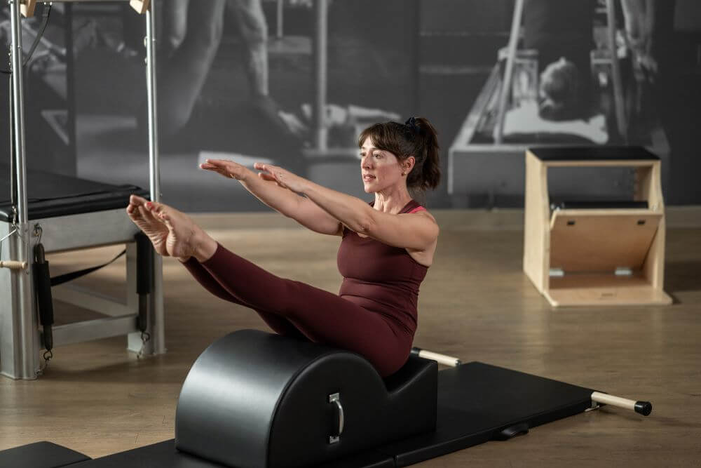 Sieviete vingro ar Contrology Spine Corrector Pilates studijā.