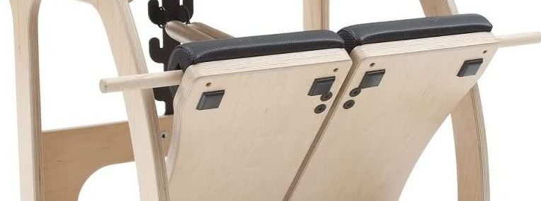Pilates aprīkojums ar dalītu kāju platformas dizainu un neslīdošu polsterējumu.