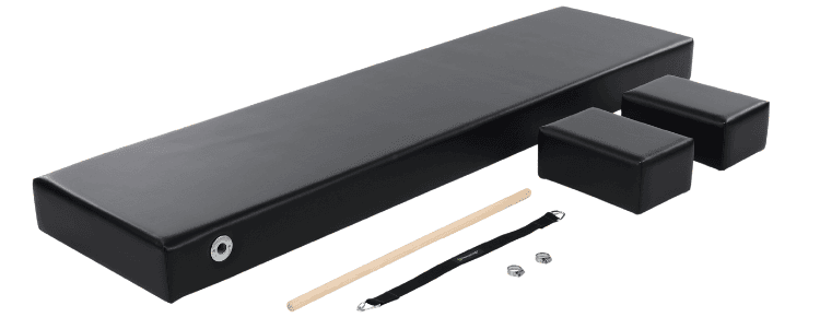 Black upholstered Pilates mat with dowel handles, foot strap, and Moon Boxes.