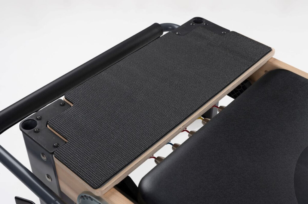 Rialto Standing Platform Extender on a Reformer, close-up view.